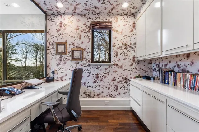 a view of pool with table and chairs under an umbrella
