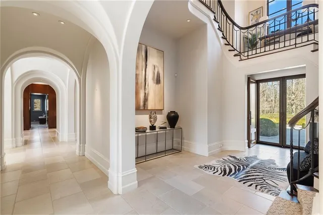 a living room with furniture and floor to ceiling windows