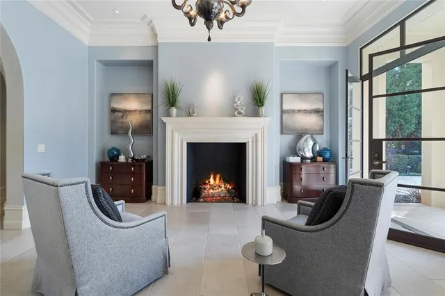 a living room with furniture a fireplace and a floor to ceiling window