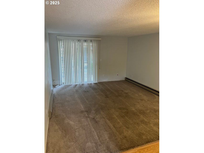 3404 19th Avenue, Unit 103 Forest Grove, OR 97116 - Photo 2 of 10 a view of an empty room with windows