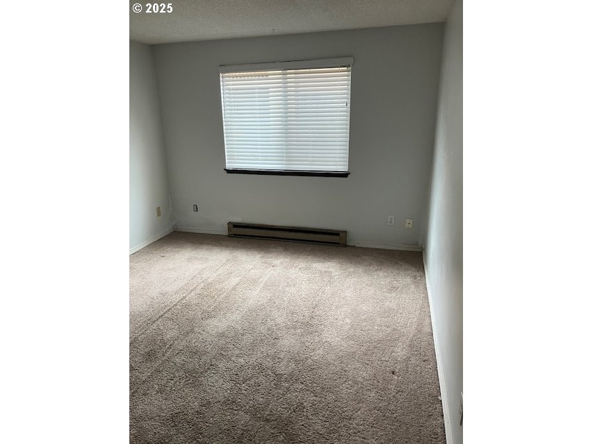3404 19th Avenue, Unit 103 Forest Grove, OR 97116 - Photo 5 of 10 a view of an empty room with a window