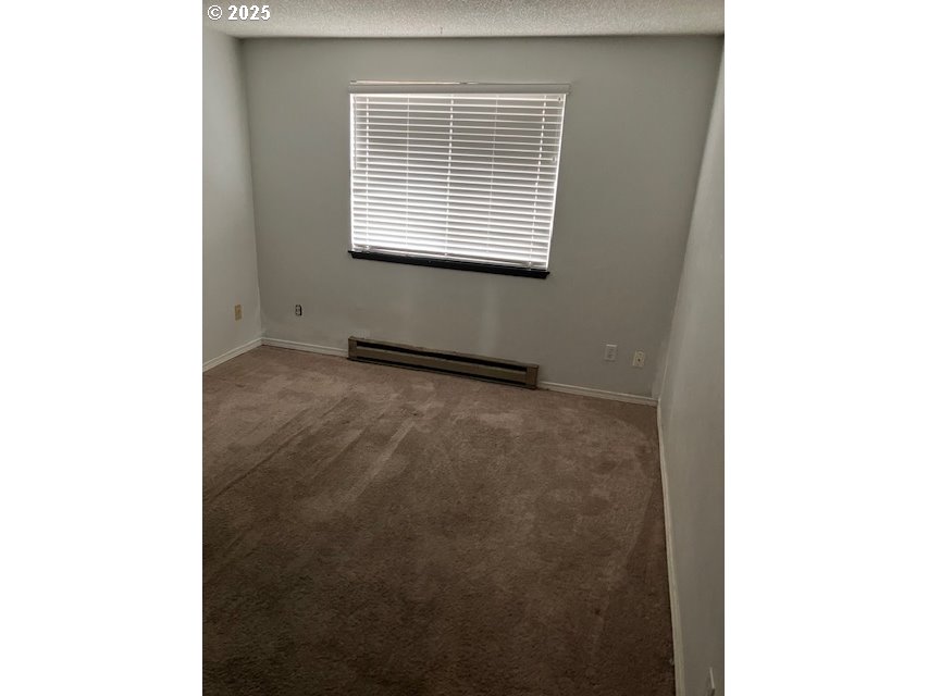 3404 19th Avenue, Unit 103 Forest Grove, OR 97116 - Photo 8 of 10 a view of an empty room with a window