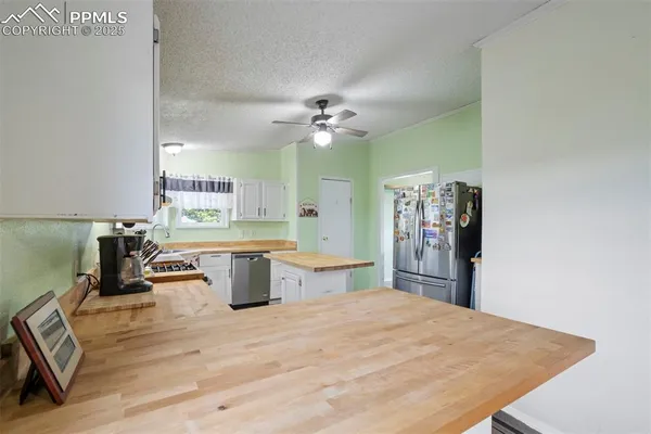 a open kitchen with a table chairs and a stove