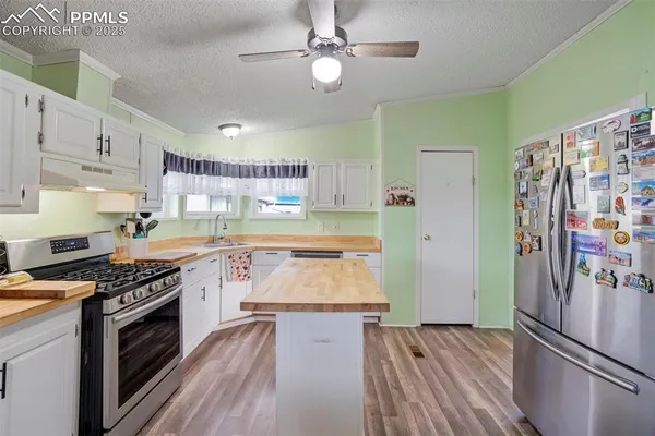 a kitchen with stainless steel appliances granite countertop a stove and a refrigerator
