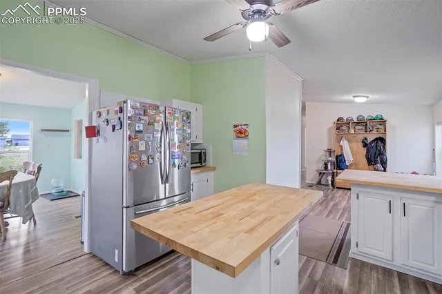 a room with kitchen island a wooden floor and chandelier