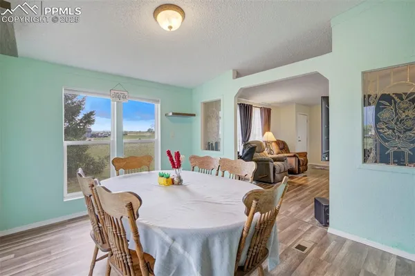 a view of a dining room with furniture and wooden floor