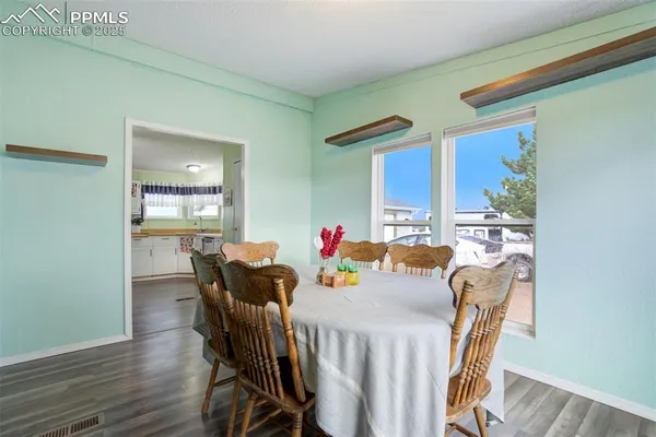 a view of a dining room with furniture window and wooden floor