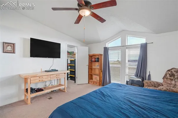 a bedroom with furniture and flat screen tv