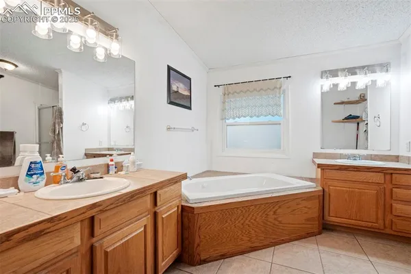 a bathroom with a tub sink and mirror
