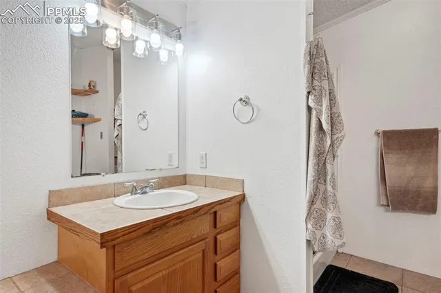 a bathroom with a sink vanity and a mirror