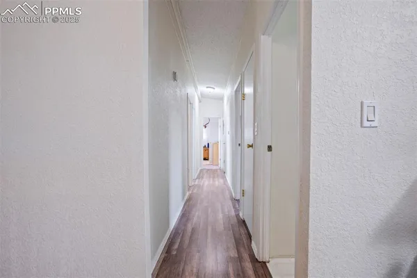 a view of a hallway with wooden floor