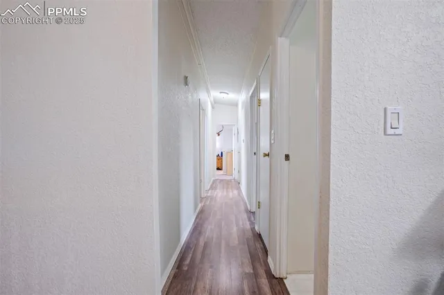 a view of a hallway with wooden floor