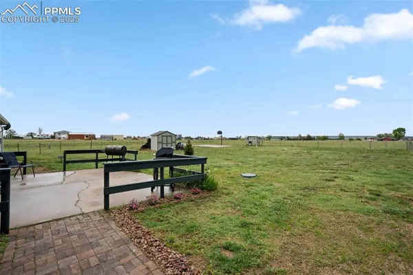 a view of a bench in a backyard of a house