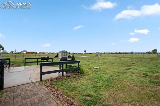 a view of a bench in a backyard of a house