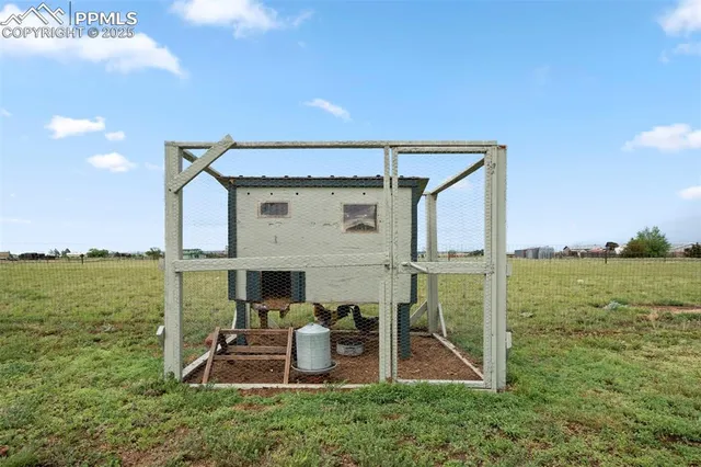 a view of a patio with chair and table of the ocean