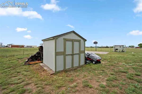 a backyard of a house with lots of green space and outdoor seating