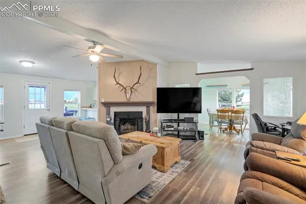 a living room with furniture a fireplace and a flat screen tv
