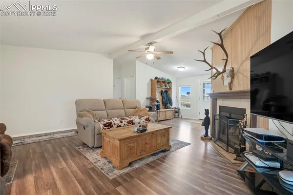 a living room with furniture a flat screen tv and a fireplace