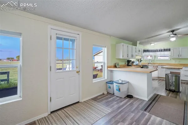 a kitchen with white cabinets and counter space
