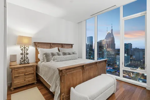 a bedroom with a large bed and a window