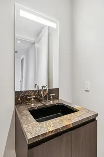 a kitchen with a sink and a mirror