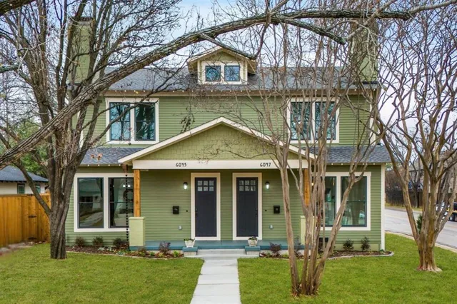 a living room with fireplace furniture and a wooden floor