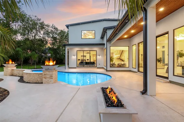 an outdoor space with swimming pool and furniture