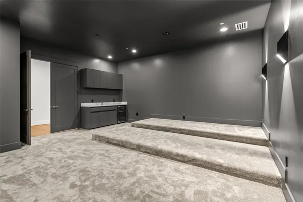 an empty room with windows and ceiling fan