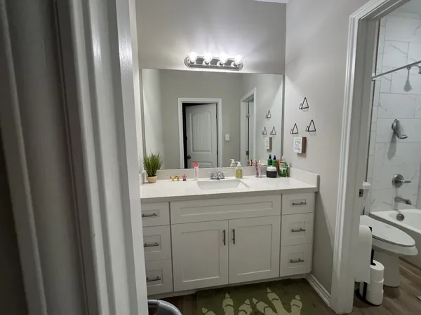 a kitchen with kitchen island a sink appliances and cabinets