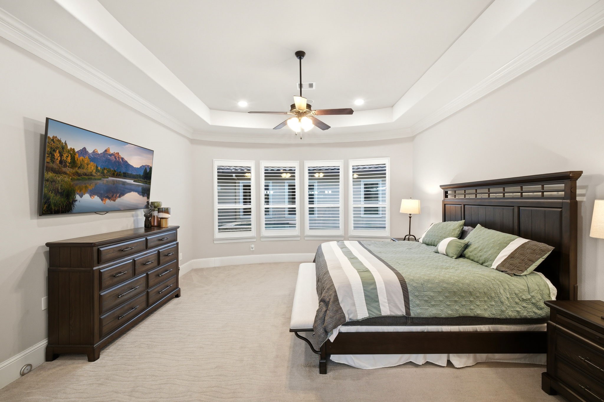 5815 Stratton Woods Drive Spring, TX 77389 - Photo 31 of 45 a bedroom with a large bed and a flat tv screen on dresser