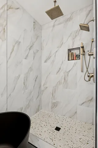 a bedroom with a bed couch and a window