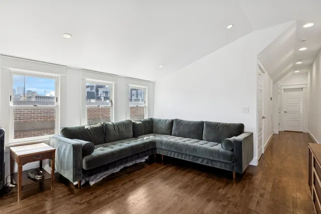 a view of a workspace with furniture and wooden floor