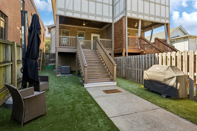 a view of a backyard with a small cabin and a chair