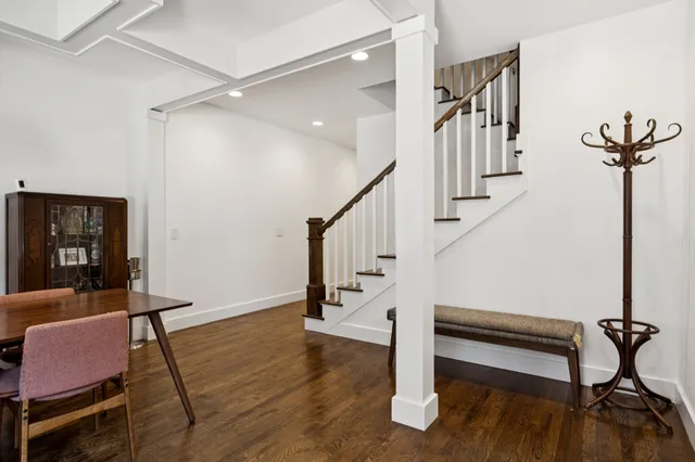 a view of entryway and hall with wooden floor