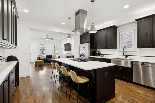 a kitchen with counter top space a sink appliances and cabinets