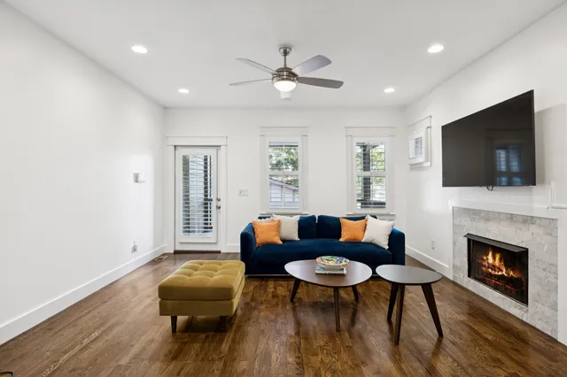 a living room with fireplace furniture and a flat screen tv