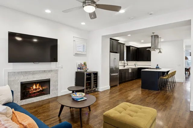 a living room with furniture a fireplace and a flat screen tv