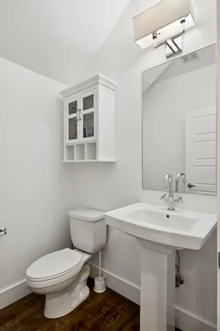 a bathroom with a sink toilet and mirror