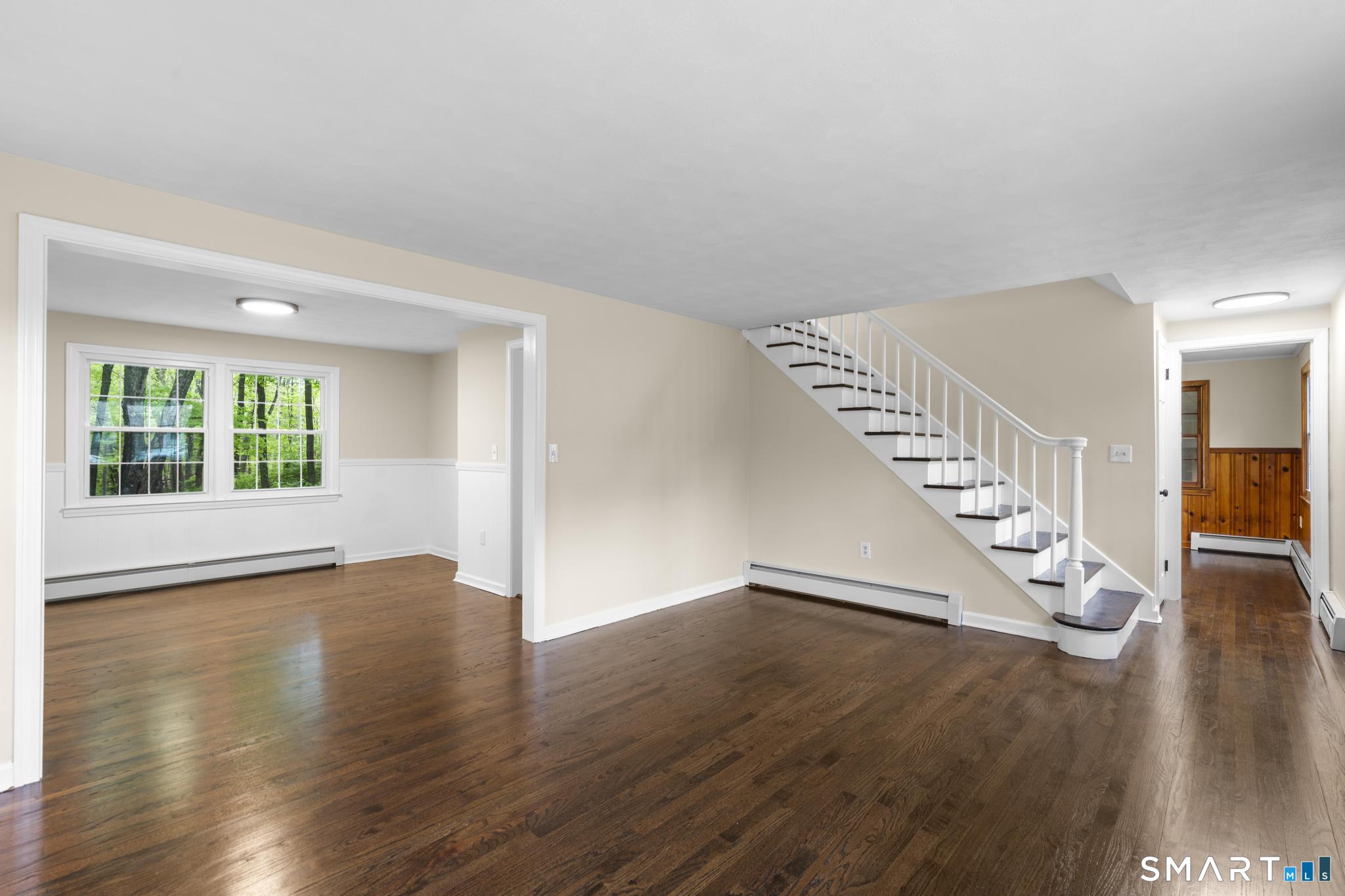 7 Sycamore Terrace Windham, CT 06280 - Photo 6 of 40 a view of an empty room with wooden floor and a window