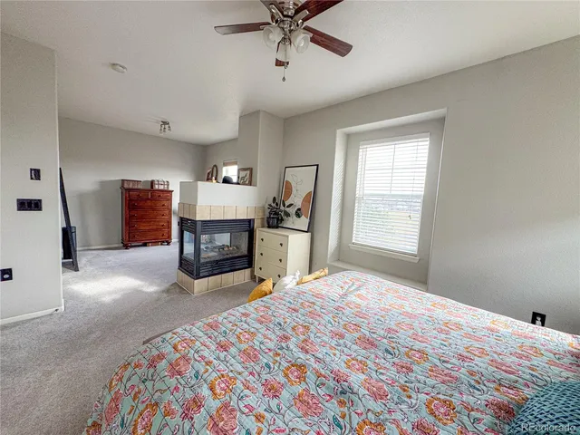 a bedroom with a bed and a fireplace