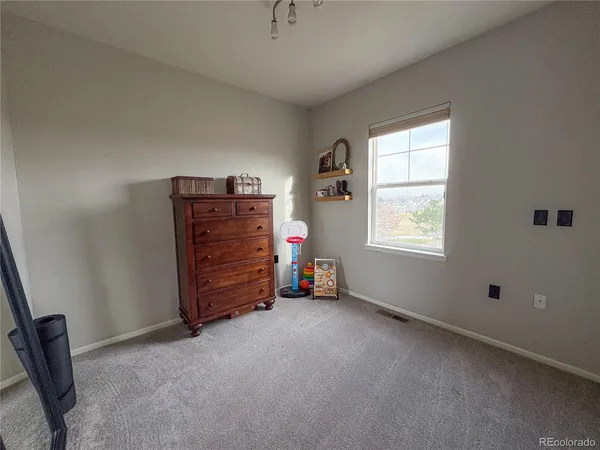 an empty room with windows and closet
