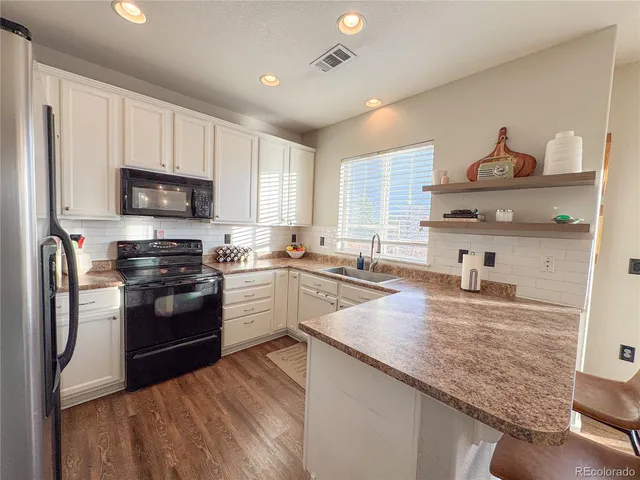 a kitchen with granite countertop stainless steel appliances and wooden cabinets