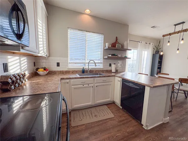 a kitchen with a sink stove and cabinets