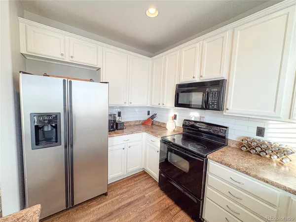 a kitchen with a refrigerator stove and microwave