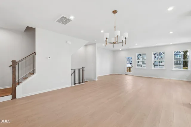 a large kitchen with granite countertop a sink a counter space stainless steel appliances and cabinets