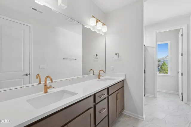 a view of a livingroom with a furniture wooden floor and chandelier