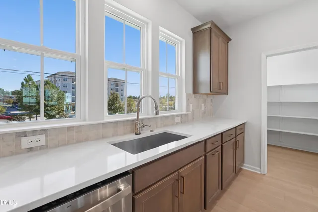a kitchen with a large counter top a sink and cabinets