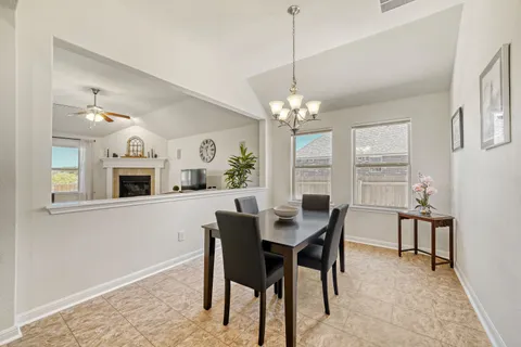 a view of a dining room with furniture and a chandelier