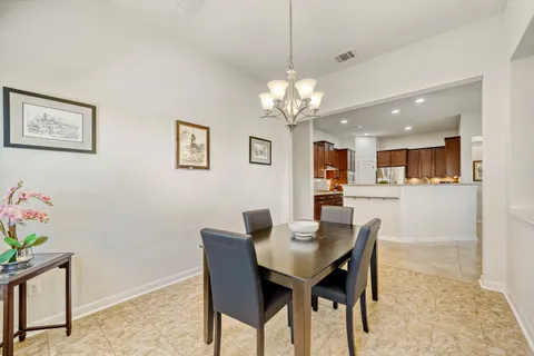 a view of a dining room with furniture and chandelier