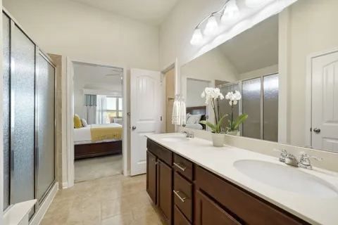 a en suite bathroom with double vanity and a mirror